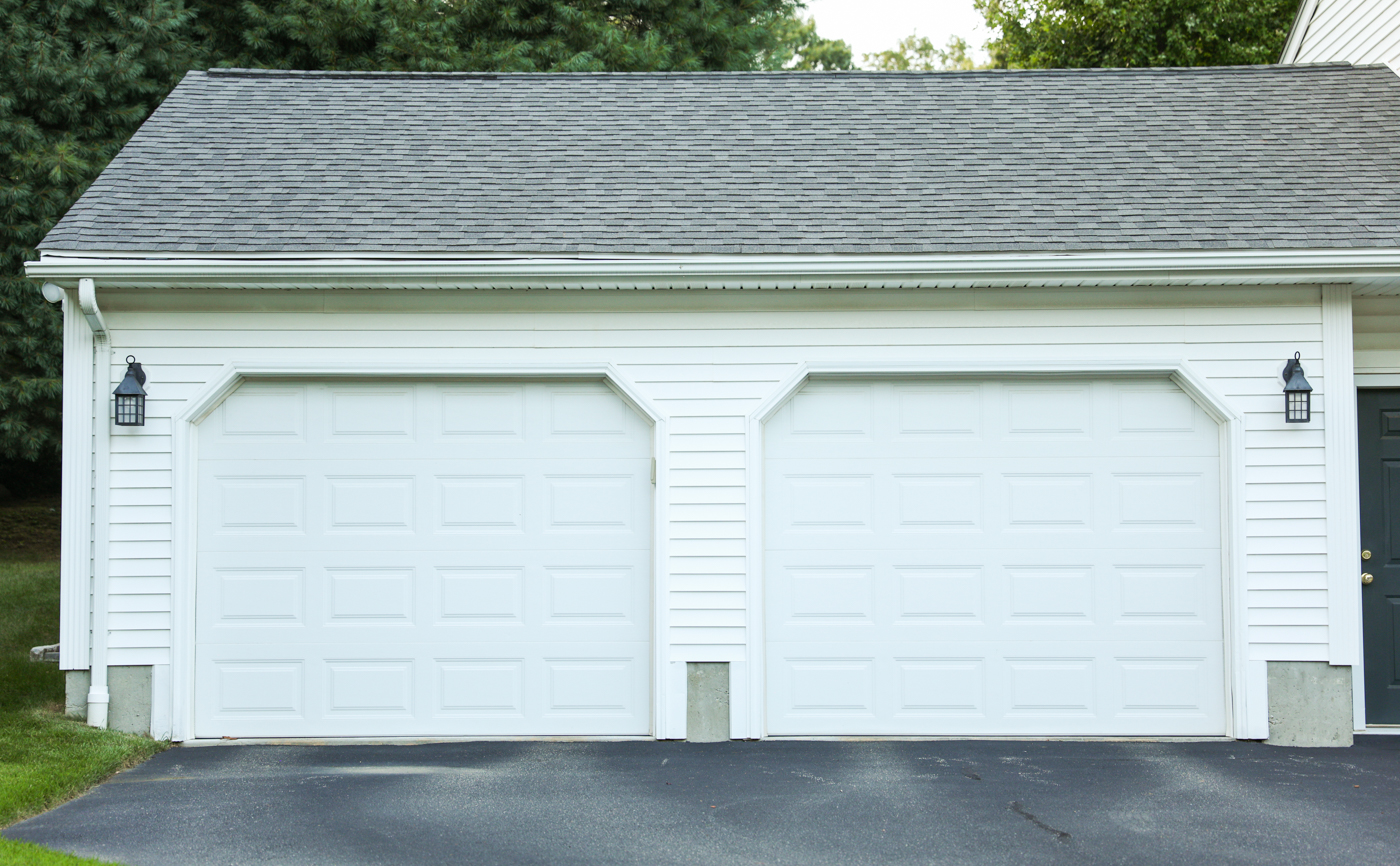Modern wood-look garage doors on Canadian home driveway