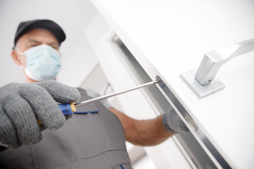 Locksmith installing lock in Canadian apartment door