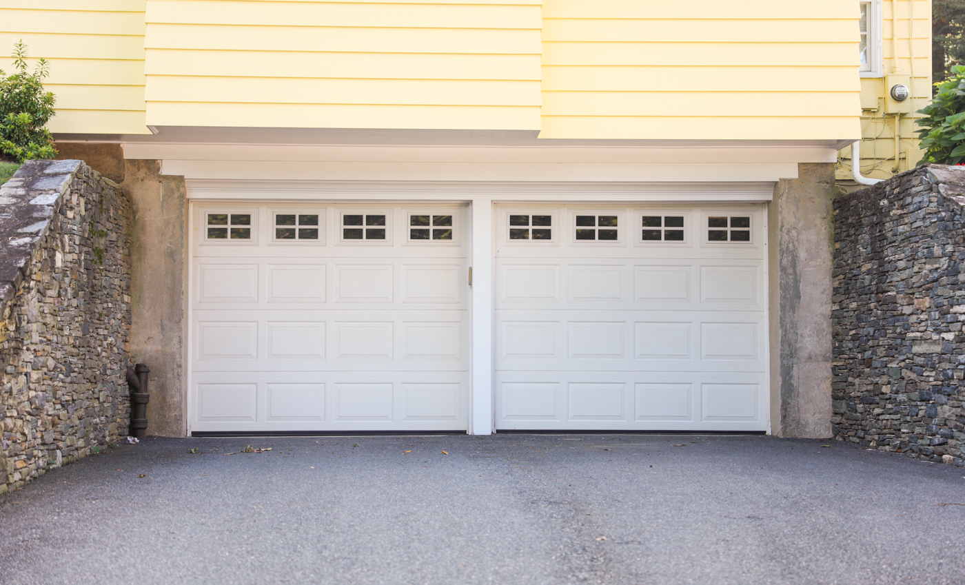Modern white garage door on suburban Canadian home