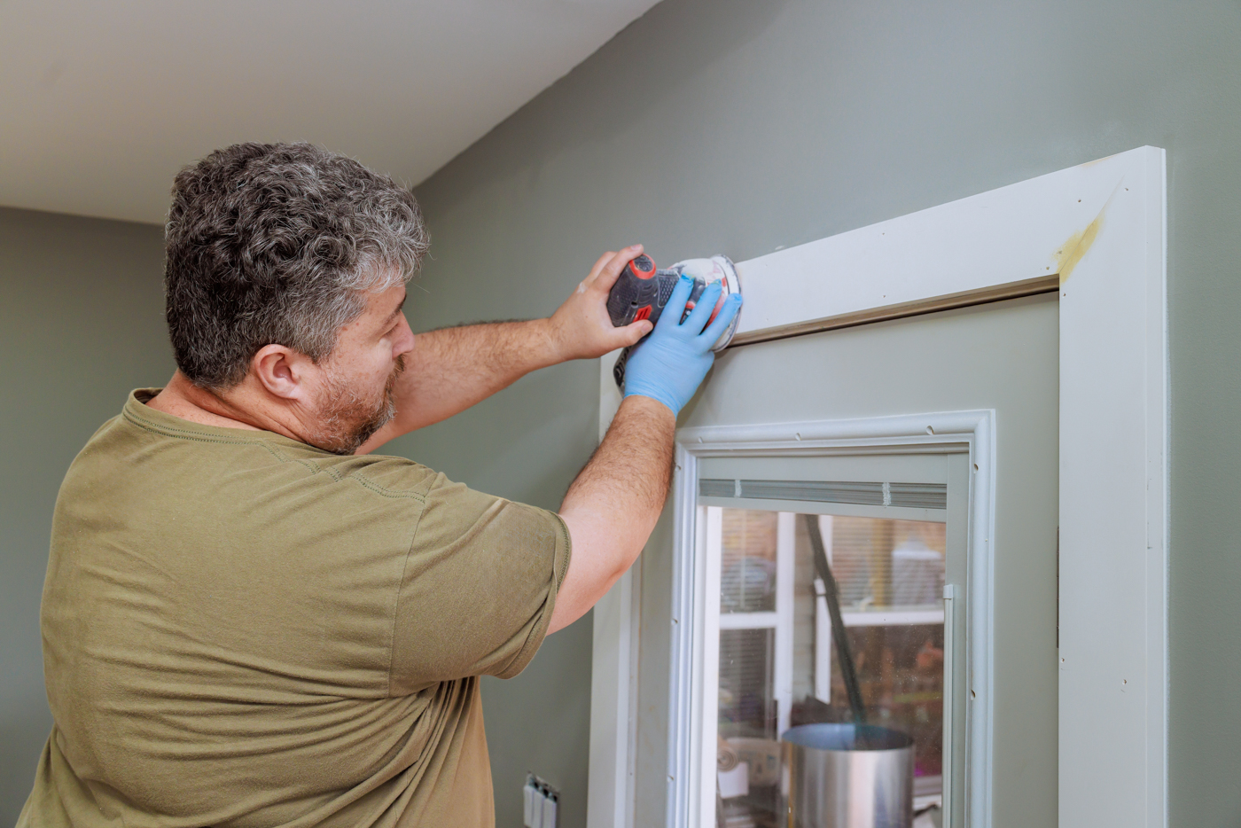 Window insulation film being installed in Canadian home