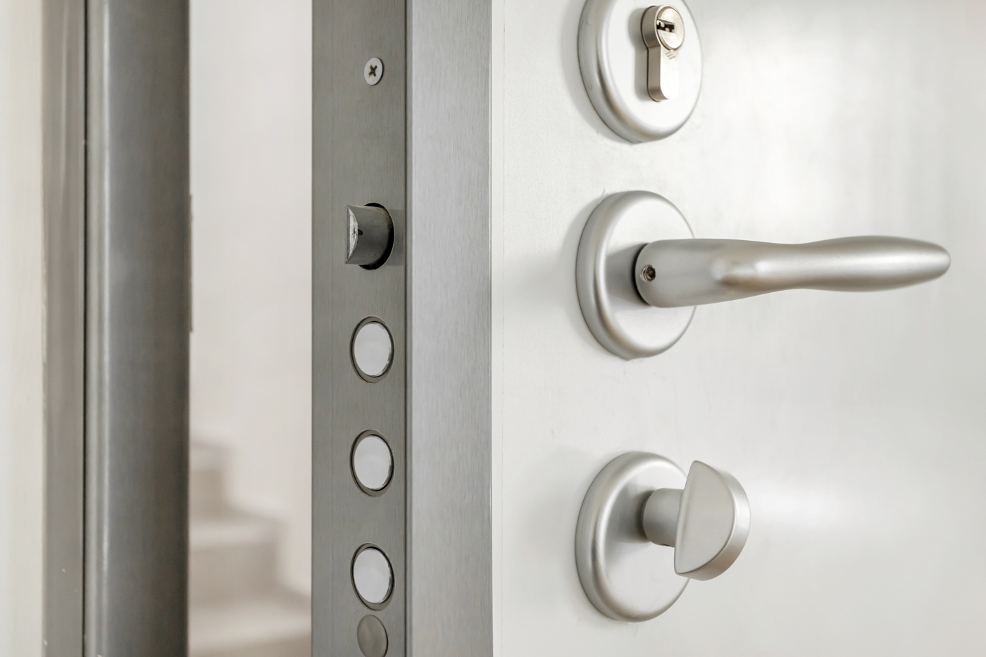 Brass cylinder lock with house keys on black surface