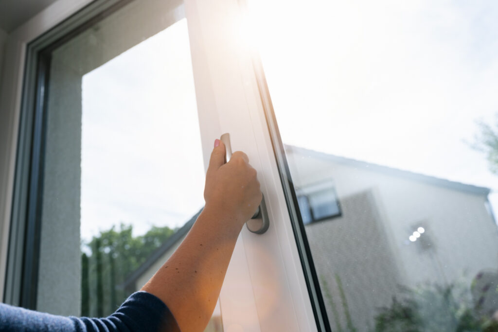 Opening modern vinyl patio door in Canadian home