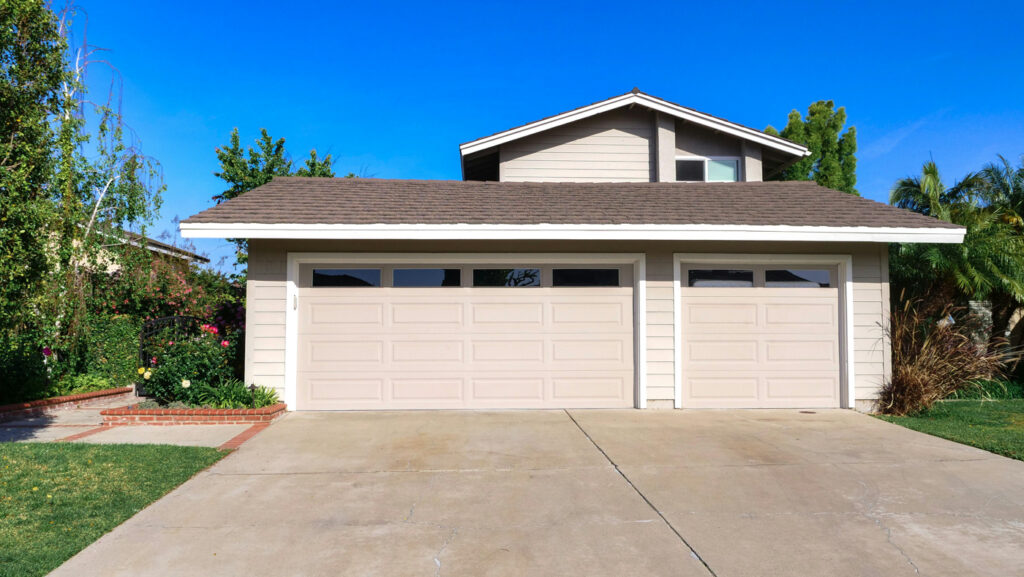 Modern residential garage doors on Canadian home driveway