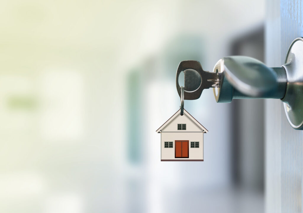 Key in door with house keychain