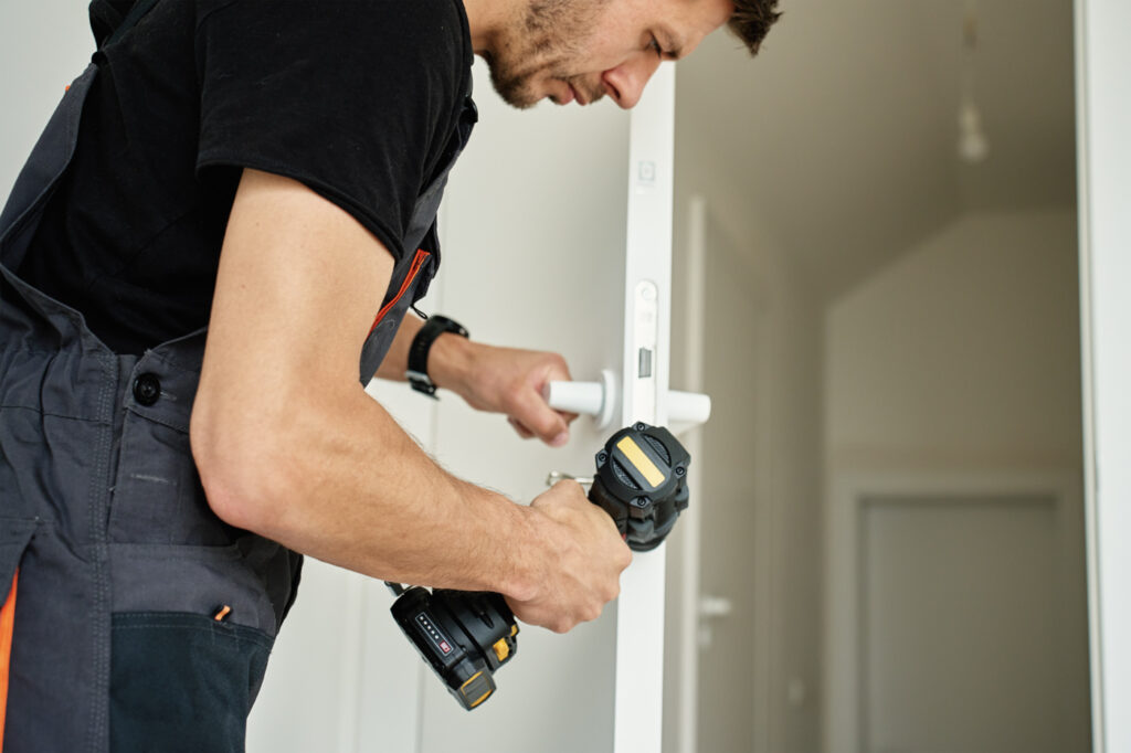 Technician installing commercial door