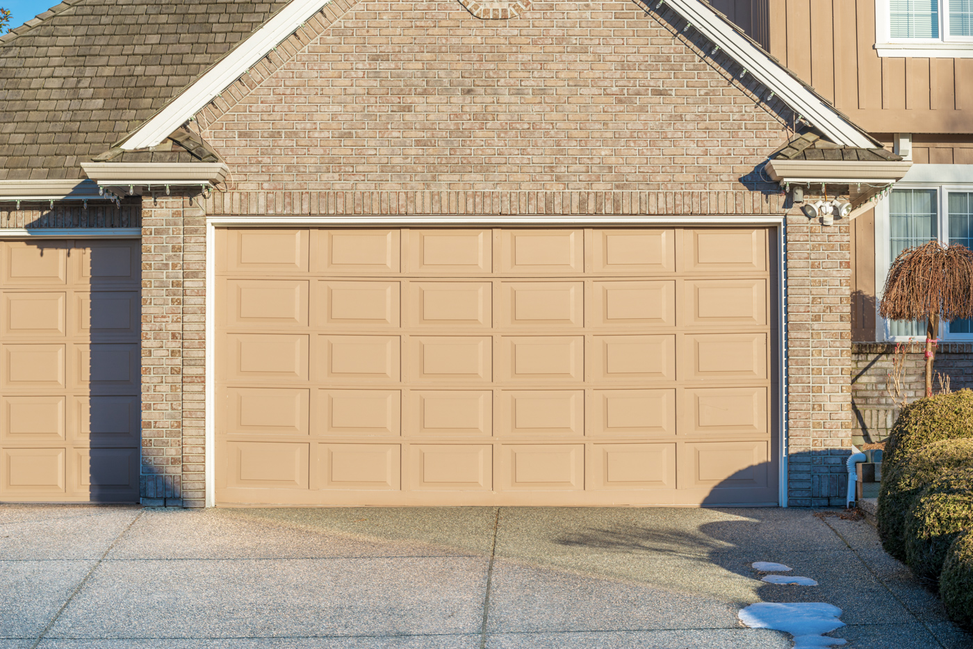 Large residential home with three garage doors