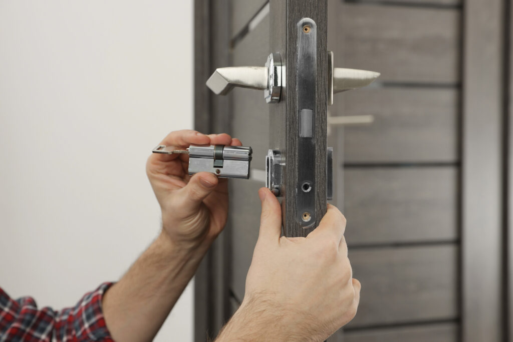 Locksmith installing door lock