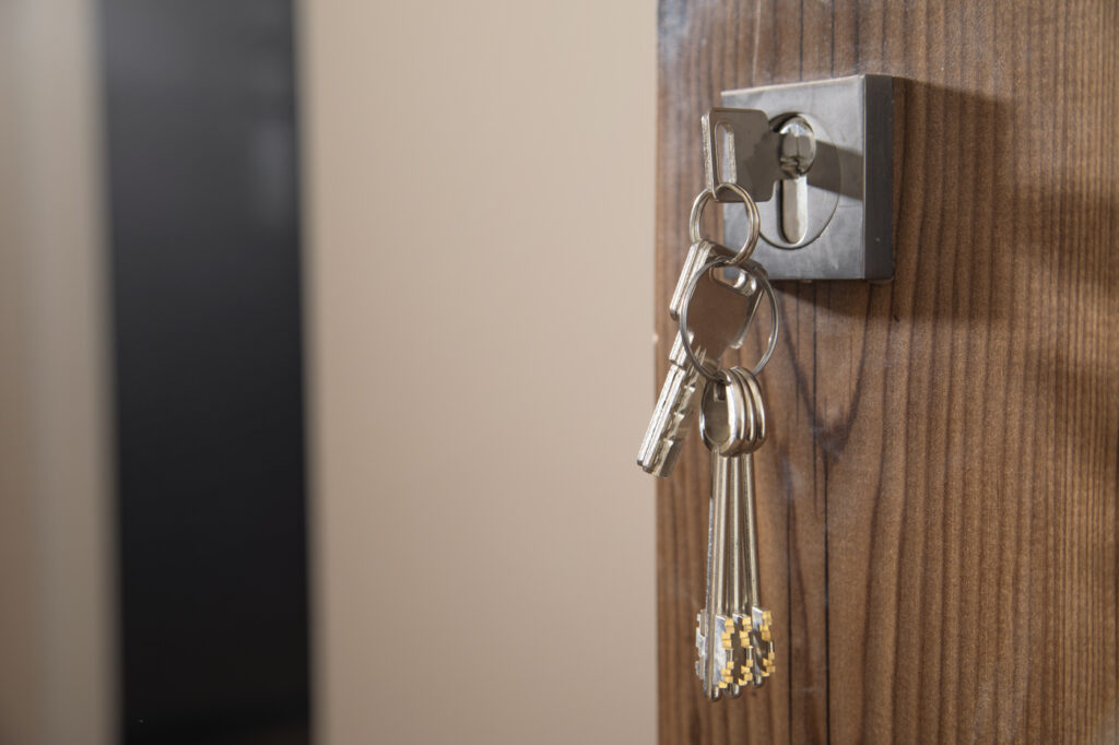 Keys in a deadbolt on wooden door