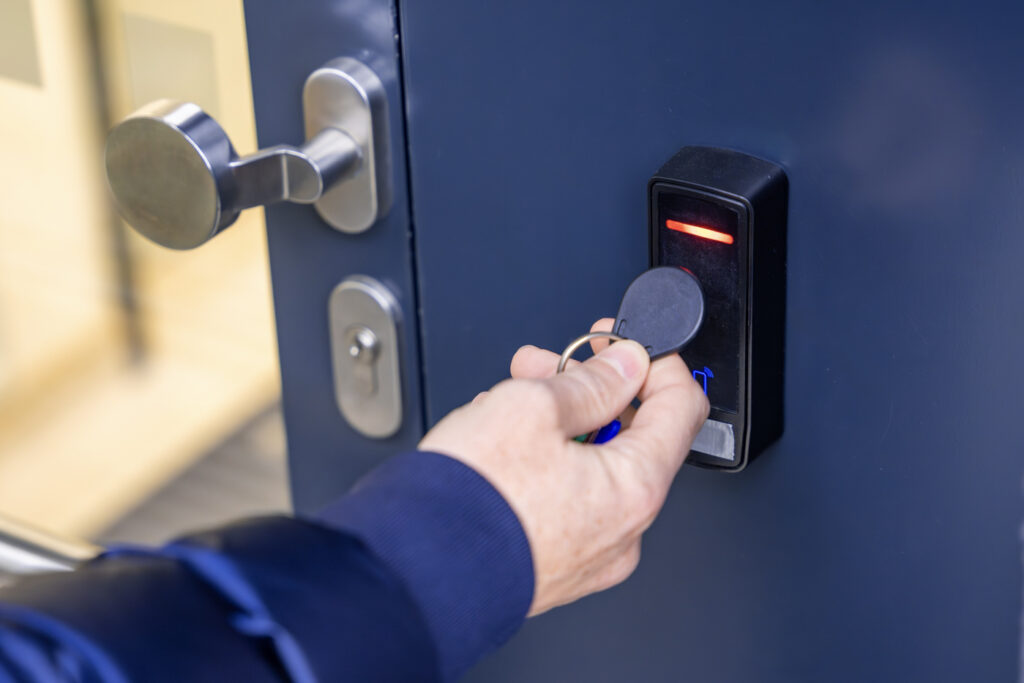 Hand accessing smart lock with fob