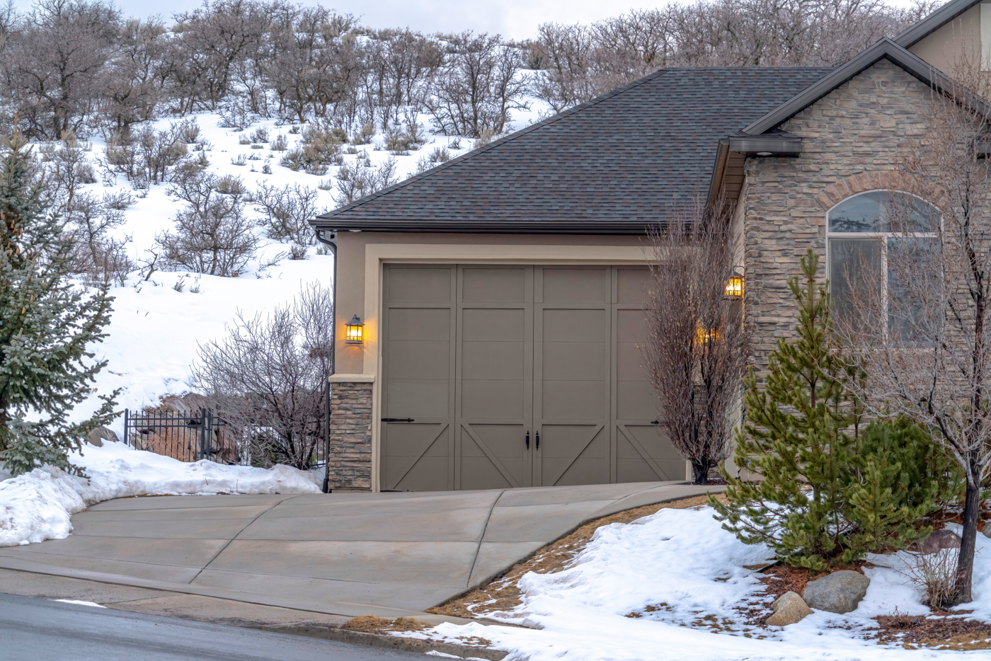 Modern white garage door in snowy driveway