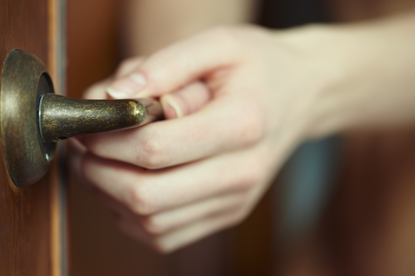 Hand holding key near digital locks